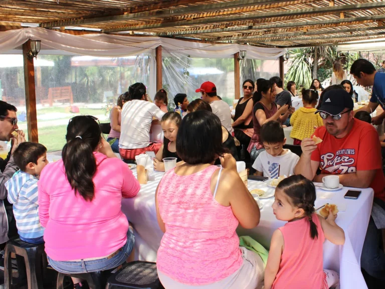Familias compartiendo un desayuno bajo una pérgola